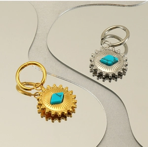 Detailed close-up of retro bohemian sunflower earrings with turquoise stone inlays