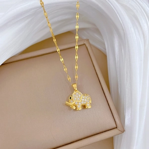 Luxurious gold titanium elephant necklace with micro-pave crystals on white fabric