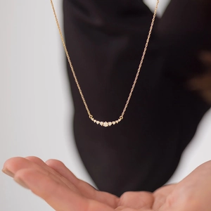 Elegant gold smile necklace with seven gradient zircons on a delicate chain for women