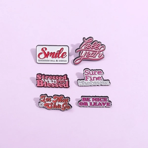 Set of six creative enamel lapel pins with inspirational English slogans on purple background