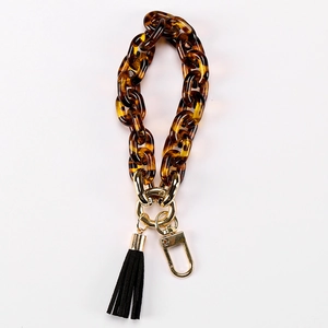 Acrylic tortoiseshell chain bracelet with black tassel and golden metal lobster clasp