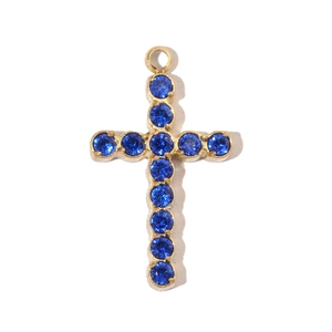 Detailed view of a gold stainless steel cross pendant with inlaid blue round gemstones
