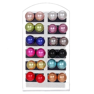 Set of 12 pairs of multi-color faux pearl stud earrings displayed on a vertical rack