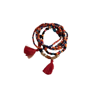 Bohemian multilayer seed bead bracelet with vibrant colorful beads and red tassels charms