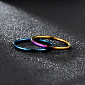 Macro shot of 2mm minimalist stainless steel rings in blue and purple gradient finishes