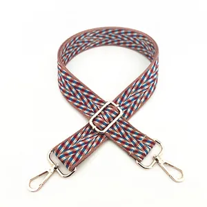 Detail of chevron weave cotton bag strap with adjustable golden metal hardware