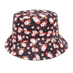 Detail of black festive bucket hat featuring all-over Santa Claus and snowflake pattern