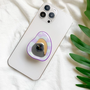 Detail of a purple checkered mirror phone socket grip on a white smartphone back