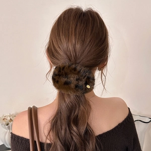 Chic leopard print faux fur hair clip accessory styled on brunette hair for autumn fashion