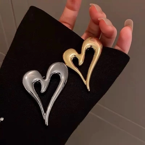Minimalist heart-shaped gold and silver brooches in a sleek metallic finish