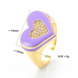 Detail shot of a purple enamel heart ring with micro-pave crystals and golden finish