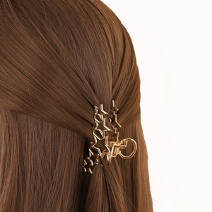 Elegant gold star-shaped hollow shark hair claw clip styled on long brown hair