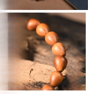 Macro detail of high-density teardrop shaped thuja wood beads with natural oily luster