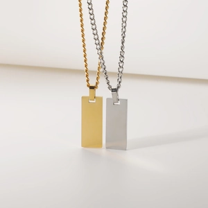 Detailed view of rectangle pendant necklaces in polished gold and silver stainless steel