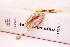 Close-up of sparkling rhinestone red lips keychain with a mini lipstick charm accessory