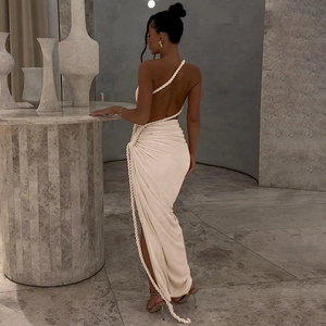 Detail view of the rope strap design and backless cutout on this off-white maxi dress
