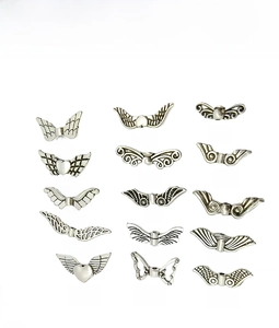 Detailed grid of 15 vintage tibetan silver angel wing and feather charms for DIY jewelry