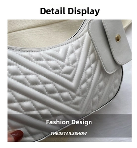 Detail of white quilted V-stitch shoulder bag with detachable mini pouch and gold hardware