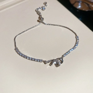 Detail of zircon bow bracelet with adjustable slider clasp and sparkling pavé setting