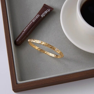 Elegant 18k gold plated hammered stainless steel bangle with sparkling crystal stones