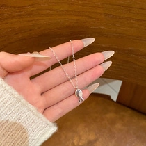 Detailed close-up of a silver fish-shaped pendant necklace with polished finish