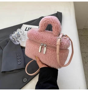Pink faux fur handbag detail with silver zippers and a matching leather shoulder strap