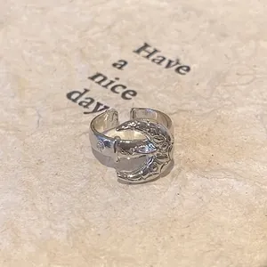 Detail view of engraved crescent moon silver ring with intricate vintage texture