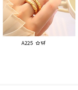 Macro shot of two golden irregular textured rings with creative fox design on a hand