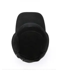 Detail view of the thick wool lining and adjustable metal buckle of this black winter cap