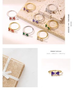 Detailed view of colorful bow zircon rings in gold and silver finish with gift box