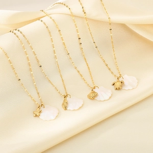 Gold stainless steel ocean necklaces with shell, starfish, and turtle pendants on silk