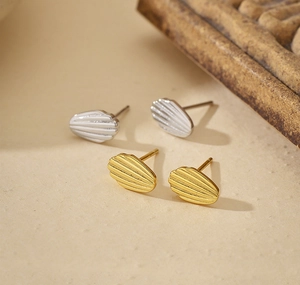 Macro shot of S925 silver shell pattern earrings in gold and silver finishes