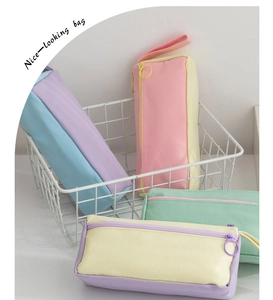 Close-up of pastel canvas pencil cases with large ring zippers and side handles