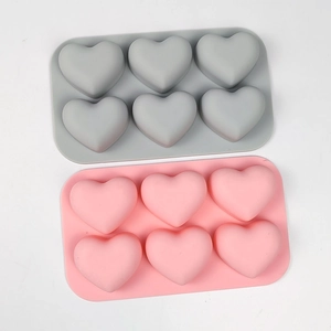 Detail view of pink and grey 6-cavity heart silicone molds for mousse and chocolate