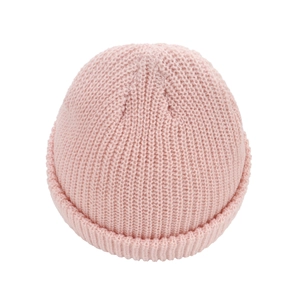 Close-up of baby pink knitted beanie showing soft ribbed texture and rolled cuff detail