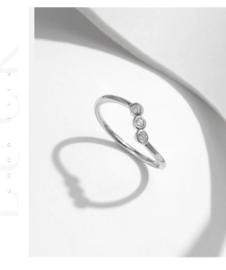 Macro view of three vertically aligned Moissanite stones on an S925 silver ring
