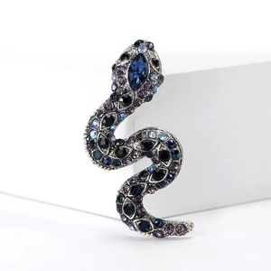 Macro detail of vintage snake brooch with colorful rhinestones on silver finish