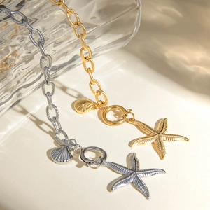 Detailed close-up of 18k gold ocean starfish and shell charms on a thick metal chain