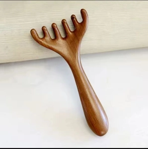Five-tooth sandalwood scalp massage comb with smooth ergonomic handle on dual-color background