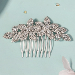 Detail of silver wedding hair comb with sparkling crystals and floral leaf pattern