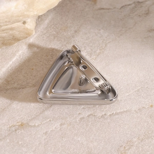 Macro shot of silver chunky triangular brooch back with secure safety pin closure