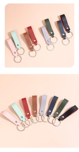 Detail view of colorful lychee grain leather keychains with silver metal ring and rivets
