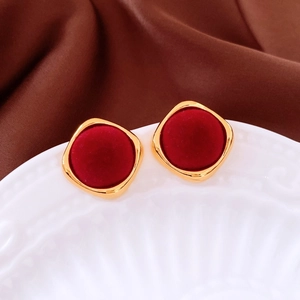 Macro shot of retro burgundy flocked earrings with gold metal frames in a diamond shape