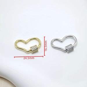 Macro shot of gold and silver heart-shaped screw clasps with zircon detail, 24.5x16.5mm size
