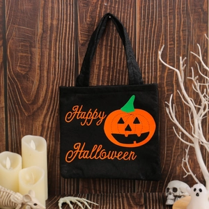 Black Halloween candy tote bag featuring an orange pumpkin and Happy Halloween text