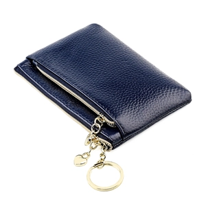 Detail of navy blue pebble leather coin purse with double zippers and heart pendant