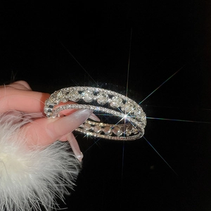 Macro shot of silver multi-layer floral bracelet with sparkling zircon stones