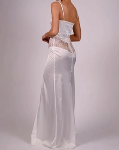 Detail of white satin maxi dress with delicate lace waist stitching and slender straps
