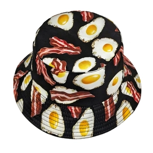 Unisex black bucket hat featuring creative fried egg and bacon food pattern print