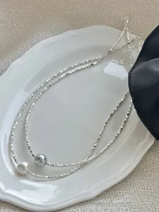 Close-up of S925 silver beaded necklace featuring a purple and white pearl pendant